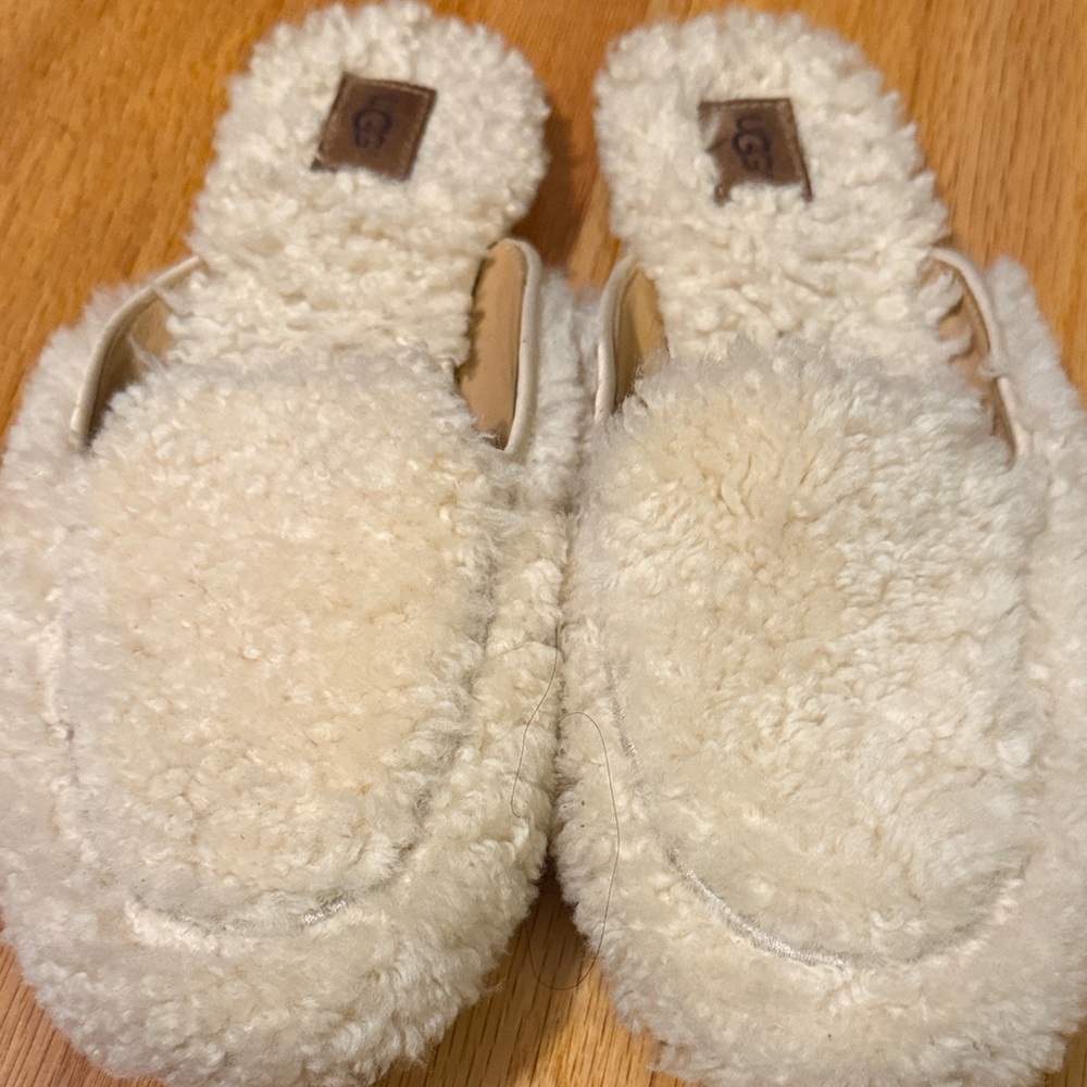 UGG Cream Fuzzy Mules Leather Patch Logo With Satin Trim.